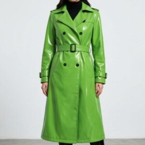 Front view of a woman wearing a long glossy green trench coat with double breasted buttons and waist belt